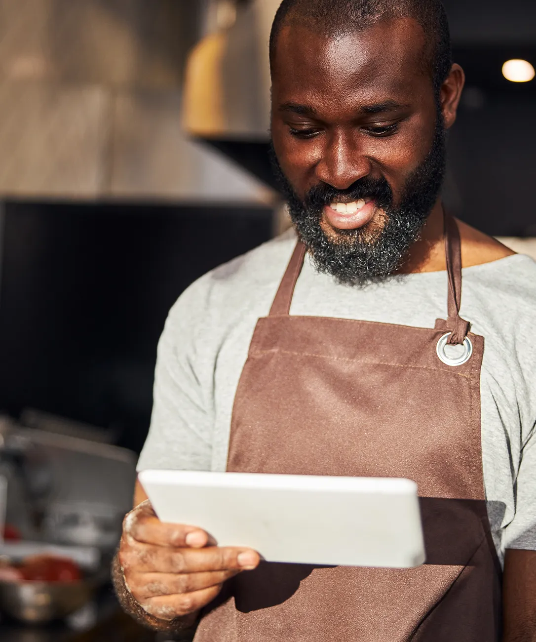 A restaurant owner looking at Snappy restaurant tablet
